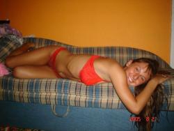 Tanned brunette beauty posing on her sofa serie 76 2/9