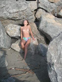 Brunette teen teasing on nude beach 12/46