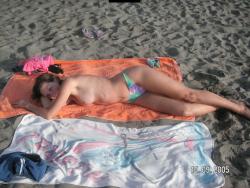 Brunette teen teasing on nude beach 19/46