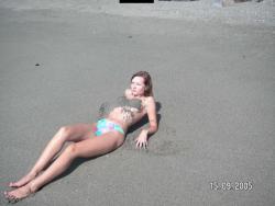 Brunette teen teasing on nude beach 39/46